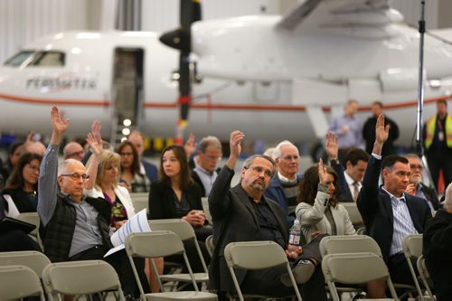 WAYNE GLOWACKI / WINNIPEG FREE PRESS 

Michael Pyle, CEO, in centre, at the Exchange Income Corp. annual meeting held in the Calm Air hangar Wednesday. 
Martin Cash  story  May 10 2017