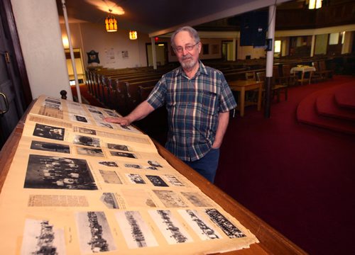 WAYNE GLOWACKI / WINNIPEG FREE PRESS 

Faith Page. Building manager, Dan McCulloch with the big church register, it measures 2 by 3 feet and is 100 years old in the  Gordon-King Memorial Church at 17 Cobourg Ave.   For Brenda Suderman story on Church tours.  May 11 2017