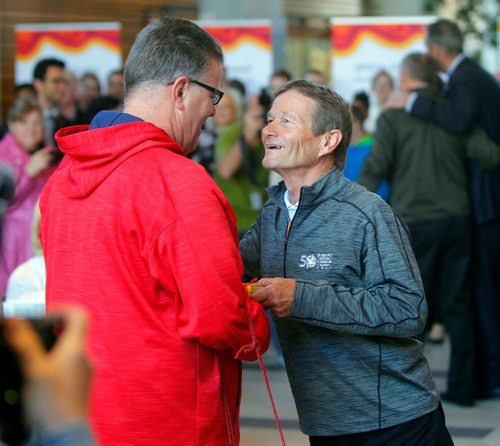 BORIS MINKEVICH / WINNIPEG FREE PRESS
CANADA GAMES TORCH RELAY EVENT - The 2017 Canada Games Host Society had an event at MB Hydro headquarters to honour and celebrate individuals who will carry the Roly McLenahan Torch, as part of the Manitoba Hydro Torch Relay. From left, Dancing Gabe gets greeted by Hubert Mesman, Co-Chair of the 2017 Canada Summer Games in Winnipeg. CAROL SANDERS STORY. May 12, 2017