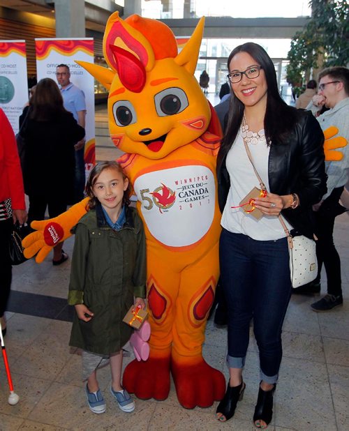 BORIS MINKEVICH / WINNIPEG FREE PRESS
CANADA GAMES TORCH RELAY EVENT - The 2017 Canada Games Host Society had an event at MB Hydro headquarters to honour and celebrate individuals who will carry the Roly McLenahan Torch, as part of the Manitoba Hydro Torch Relay. From left, Mila Gaslard,7, 2017 Canada Summer Games Mascot Niibin, and Mila's mother Kimberly Moors. CAROL SANDERS STORY. May 12, 2017