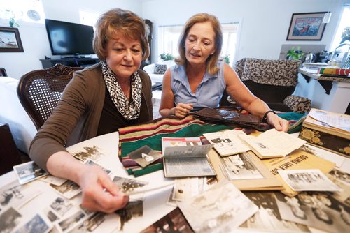 JOHN WOODS / WINNIPEG FREE PRESS
Dorothy Rhymer (L) and Christine Tabbernor look at family photos and momentos of  Rhymer's mother Janina Zwierciadlowski who spent time in a Mexico refugee camp during WW11 photographed on Monday, May 15, 2017