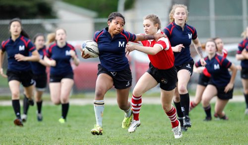 PHIL HOSSACK / WINNIPEG FREE PRESS  -   St Mary's Acadamy #12 Jummy Akinola runs through Kelvin Clipper opposition Tuesday at Kelvin. The cross street rivals met on the rugby field Tuesday afternoon. -  May 16, 2017