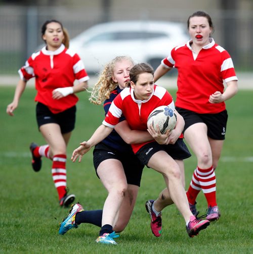 PHIL HOSSACK / WINNIPEG FREE PRESS  -   Kelvin Clipper #11 Catheryn Wolyshyn takes a tackle from St Mary's Acadamy #6 Ashley M. Tuesday at Kelvin. The cross street rivals met on the rugby field Tuesday afternoon. l  -  May 16, 2017