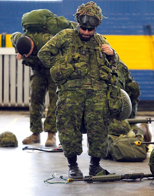 PHIL HOSSACK / WINNIPEG FREE PRESS  - - Members of the Fort Garry Horse ready themselves for battle fitness training on Winnipeg Streets Tuesday evening at the McGregor Armoury. Members of "A" squad marched 13km on the streets surrounding the armoury carrying 24.5kg of gear including a service rifle (unloaded). Each year, soldiers must complete this training in order to ensure battle readiness. About half a dozen of theReserve squad have served in active duty in Afghanistan. See release. -  May 16, 2017