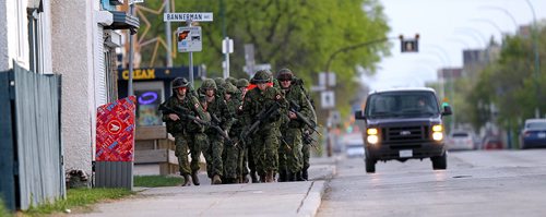PHIL HOSSACK / WINNIPEG FREE PRESS  - - Members of the Fort Garry Horse ready themselves for battle fitness training on Winnipeg Streets Tuesday evening at the McGregor Armoury. Members of "A" squad marched 13km on the streets surrounding the armoury carrying 24.5kg of gear including a service rifle (unloaded). Each year, soldiers must complete this training in order to ensure battle readiness. About half a dozen of theReserve squad have served in active duty in Afghanistan. See release. -  May 16, 2017