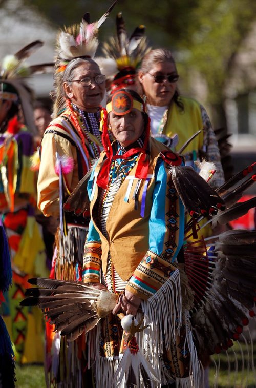 PHIL HOSSACK / WINNIPEG FREE PRESS  -  Framed in Eagle feather regalia Dwayne Gladue fronts an array of Men's Traditional Dancers at the Rossbrook House Annual Pow Wow Thursday evening. Held in the sports field at Ross Ave and Sherbrook street the annual event is in it's 35th. -  May 17 2017