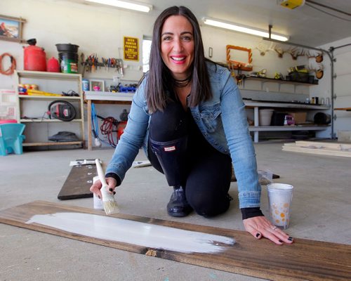 BORIS MINKEVICH / WINNIPEG FREE PRESS
INTERSECTION - Julie Carriere's business is called Coco Kisses Designs. Julie makes decorative signs for kitchens and cottages, as well as wedding boards for newly married couples (guests sign the boards), growth charts for kiddies. Here Julie paints one of her creations.  DAVE SANDERSON STORY. May 19, 2017
