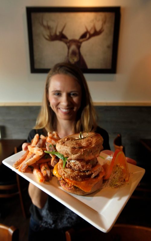 PHIL HOSSACK / WINNIPEG FREE PRESS  -  Cocoabeans Restaurant Review - Server Jacalyn Grey shows off the vegan and gluten-free cheeseburger and yam fries.

.....Alison Gilmore tale.!  -  May 19,  2017