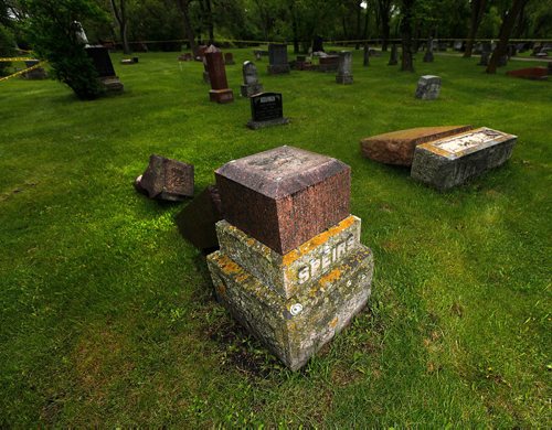 PHIL HOSSACK / WINNIPEG FREE PRESS  -   Toppled tombstones litter an older section of Brookside Cemetery Monday after wekend vandalism. See Jane Geerster's story.   -  May 22 2017