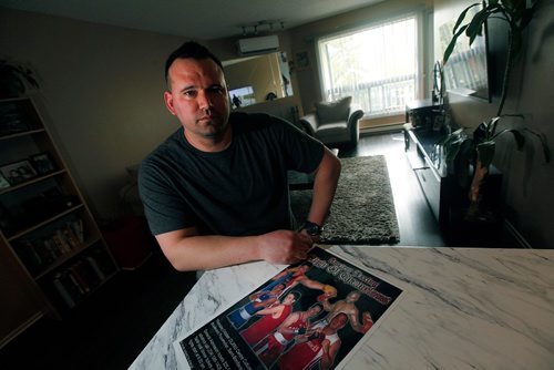 PHIL HOSSACK / WINNIPEG FREE PRESS  -   Former boxing mate to Bruce Oake, Derek Thorwesten poses with an old boxing poster in his Maples home. He and Bruce both fought in National Competitions. They are seen posing in the bottom left corner, Bruce Oake in Red, Derek in Blue. See Randy Turner feature.   -  May 22 2017