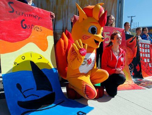 BORIS MINKEVICH / WINNIPEG FREE PRESS
From left low, The 2017 Canada Games Mascot named Niibin and Eyes of the Nation Ambassador Tracy Bowman pose for a photo with the student artists from Immanuel Christian School and the street banners they painted at the event. 2017 Canada Summer Games, organizers and volunteers are calling on the community to help prepare its host cities for the arrival of 4,000 athletes and coaches, and 20,000 visitors this summer. The community initiative, entitled Eyes of the Nation, aims to leverage the Games to build a positive image of Winnipeg, Gimli, and Kenora in the hearts and minds of all Canadiansand in the process ignite a renewed sense of pride in the community. Event took place at Transcona Centennial Square. BILL REDECOP STORY. May 23, 2017