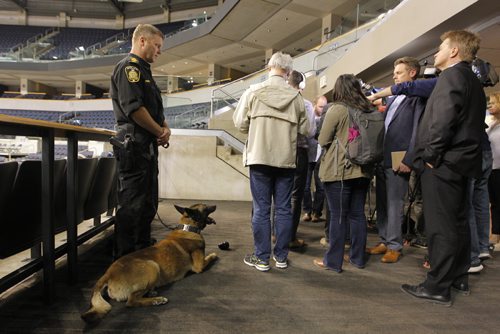 BORIS MINKEVICH / WINNIPEG FREE PRESS
Buried in a sea of reporters, Winnipeg Police Service public information officer Constable Rob Carver talks to the media at MTS Centre. Left, Sargent Dave Bessason controls Dante the explosive sniffing dog. Reaction following the bombing at Manchester Arena in England. There has been a number of media inquiries regarding security measures at the MTS Centre.  The MTS Centre works closely with the Winnipeg Police Service on security at their venue. KEVIN ROLLASON STORY. May 23, 2017