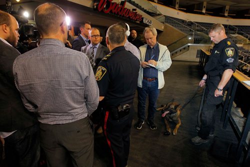 BORIS MINKEVICH / WINNIPEG FREE PRESS
Buried in a sea of reporters, left/middle, Winnipeg Police Service public information officer Constable Rob Carver talks to the media at MTS Centre. Right, Sargent Dave Bessason controls Dante the explosive sniffing dog. Reaction following the bombing at Manchester Arena in England. There has been a number of media inquiries regarding security measures at the MTS Centre.  The MTS Centre works closely with the Winnipeg Police Service on security at their venue. KEVIN ROLLASON STORY. May 23, 2017