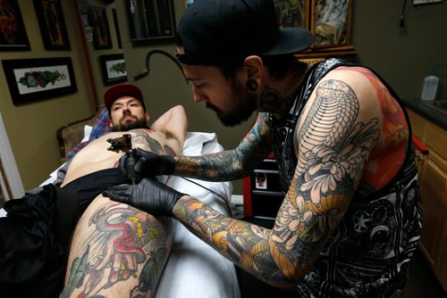 WAYNE GLOWACKI / WINNIPEG FREE PRESS 

 Keegan Misanchuk gets work on his side panel by tattooer Dan Fletcher at  Kapala Tattoo, St. Anne's Rd. Melissa Martin story   May 23 2017