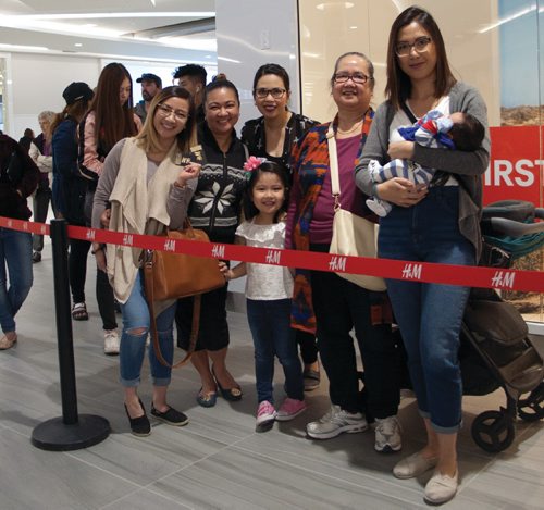 Canstar Community News May 18, 2017 - Transcona's Tanisha Tan (left) and her family showed up at 8:30 a.m. to wait in line for the new H&M at Kildonan Place to open at 11 a.m. The first 300 people in line got gift certificates to the store. (SHELDON BIRNIE/CANSTAR/THE HERALD)