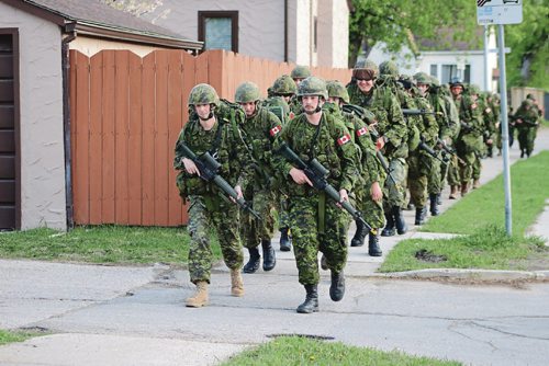 Canstar Community News May 16, 2017 - Members of the Fort Garry Horse walk the streets surrounding McGregor Armoury during a battle fitness training. (LIGIA BRAIDOTTI/CANSTAR COMMUNITY NEWS/TIMES)