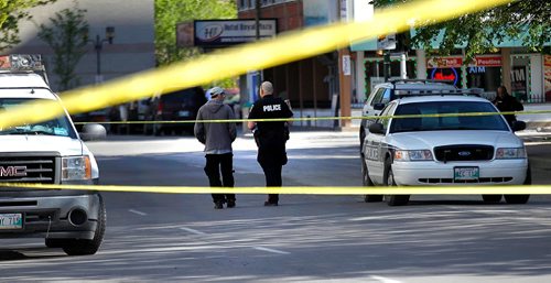 PHIL HOSSACK / WINNIPEG FREE PRESS  -  City police chat with a man on Kennedy between Ellice and Qu'Apelle street Tuesday evening near a cordoned off area of the block. Bystanders didn't know what led to the police presence.   -  May 23, 2017