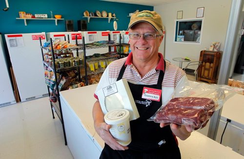 BORIS MINKEVICH / WINNIPEG FREE PRESS
Local Meats & Frozen Treats, 593 St. Anne's Rd.  Sunday Special feature on Ken Loney, 60, who opened Local Meats  & Frozen Treats  after a long, long career in the TV repair biz. Here he sits on a freezer with some of the local products he sells. DAVE SANDERSON STORY. May 24, 2017