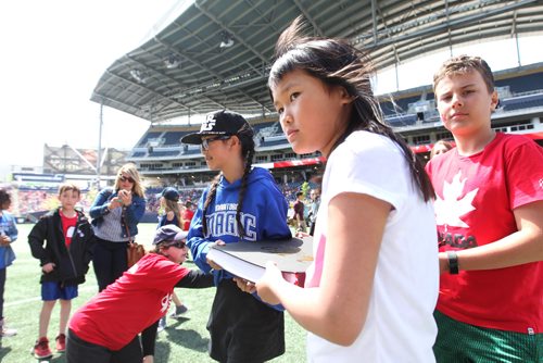 RUTH BONNEVILLE /  WINNIPEG FREE PRESS

Pembina Trails school division students present books of promises to Manitoba's  Lieutenant Governor ,Janice Filmon, on stage at Investors Group Field  as part of Canada 150 Project  where 15,000 Pembina Trails school division students gathered for event Wednesday. 

May 24, 2017