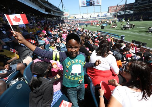 RUTH BONNEVILLE /  WINNIPEG FREE PRESS

Dami Oloko waves his little Canada flag while grouped with his fellow classmates from Ralph Maybank School in the stands of Investors Group Field with 15,000  thousand  Pembina Trails school division students for Canada 150 celebrations Wednesday. 


May 24, 2017