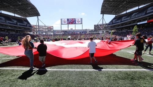RUTH BONNEVILLE /  WINNIPEG FREE PRESS

Student representatives from Pembina Trails School Division hold out a gigantic Canada Flag on Investors Group Field  as more than 15,000 students gathered at IGF for Canada 150 Project, one of the biggest school-based  events in the country on Wednesday. 

May 24, 2017