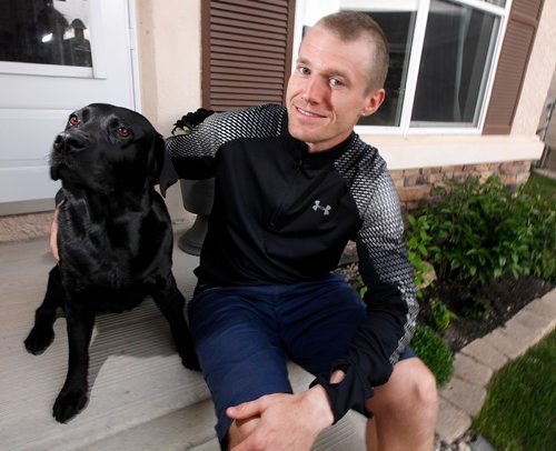 PHIL HOSSACK / WINNIPEG FREE PRESS - Corey Gallagher at home with his pooch "Nova", Corey has worked for Canada Post for the past nine years, was delivering mail in the south end of the city Tuesday morning when he came across a woman lying in the lobby of a Manitoba Housing building at Beliveau Road and Eric Street. See story.  -  May 25 2017