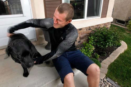 PHIL HOSSACK / WINNIPEG FREE PRESS - Corey Gallagher at home with his pooch "Nova", Corey has worked for Canada Post for the past nine years, was delivering mail in the south end of the city Tuesday morning when he came across a woman lying in the lobby of a Manitoba Housing building at Beliveau Road and Eric Street. See story.  -  May 25 2017