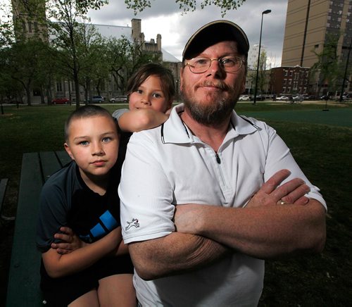 PHIL HOSSACK / WINNIPEG FREE PRESS  -   Matt Bushby poses with his children (and Claudette Osborne's) Iziah and Patience (centre) in Central Park Friday.  See Dave Baxter story.    -  May 26 2017
