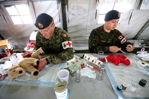 TREVOR HAGAN / WINNIPEG FREE PRESS
Private Braedan Peters and Corporal Peter Duong working in the Field Tent at the Teddy Bear Picnic, Sunday, May 28, 2017.