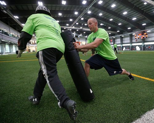 JOHN WOODS / WINNIPEG FREE PRESS
Former Blue Bomber Neil McKinlay holds the bag during  a drill for the young players at the Doug Brown KidSport Winnipeg Football Camp at the University of Winnipeg Sunday, May 28, 2017.