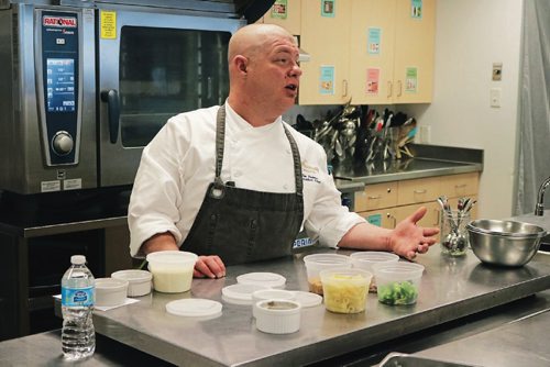 Canstar Community News May 25, 2017 - Fairmont Winnipegs executive sous chef Timothy Palmer teaches kids to make a pasta bake at the Winnipeg Harvest kitchen after Catelli announced a donation of more than 5,000 pounds of pasta. (LIGIA BRAIDOTTI/CANSTAR COMMUNITY NEWS/TIMES)