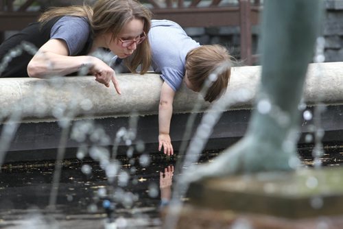 RUTH BONNEVILLE /  WINNIPEG FREE PRESS

Dominic Pirie who's almost 2yrs reacts after touching  the water with his mom, Georgina next to him  in the Leo Mol Sculpture pond at Assiniboine Park Tuesday afternoon. 
Standup photo 

May 30, 2017