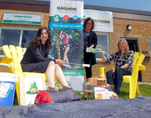 BORIS MINKEVICH / WINNIPEG FREE PRESS
Manitoba Camping Association / Sunshine Fund. Admin assist. From left, MCA admin. assistant Sydney Kazina, Exec. Dir. Kim Scherger, and programming manager Dana Moroz pose for a photo with some camping props outside their 1139 Sanford Street office. Kevin Rollason story. June 1, 2017

