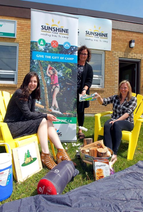 BORIS MINKEVICH / WINNIPEG FREE PRESS
Manitoba Camping Association / Sunshine Fund. Admin assist. From left, MCA admin. assistant Sydney Kazina, Exec. Dir. Kim Scherger, and programming manager Dana Moroz pose for a photo with some camping props outside their 1139 Sanford Street office. Kevin Rollason story. June 1, 2017

