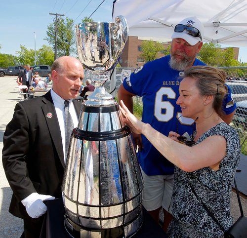 BORIS MINKEVICH / WINNIPEG FREE PRESS
Photo op for former Winnipeg Blue Bomber Chris Walby with the Grey Cup at Rasco FR on Mountain Ave. The company is proud to be launching its Canadian flagship store in Winnipeg. Rasco FR Grand Opening today and tomorrow (Friday, June 2 and Saturday, June 3) A meet and greet and pictures with Winnipeg Blue Bombers CFL Alumni Chris Walby, and The Grey Cup. A complimentary Dannys Whole Hog BBQ and Smokehouse lunch was served. From left, Keeper of the Grey Cup Jeff McWhinney, Chris Walby, and Carolyn Black(fan).  June 2, 2017
