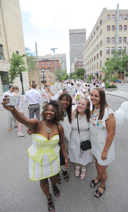 JASON HALSTEAD / WINNIPEG FREE PRESS

L-R: Lidet Getachew, Julia Dacosta, Luba Michno and Janelle Landry snap at photo at the at the north end of the Table for 1200 More dinner on Rorie Street in the east Exchange and around the Richardson Building on June 3, 2017. (See Social Page)