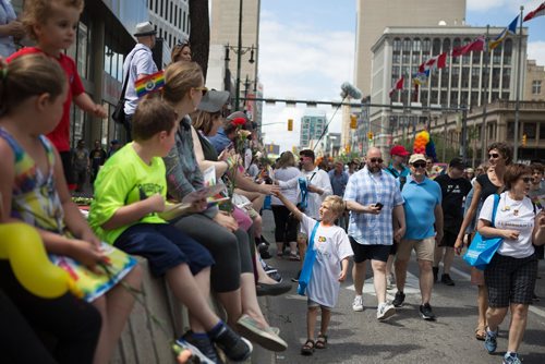 JEN DOERKSEN/WINNIPEG FREE PRESS
A young boy hands out pride stickers to supporters on Portage Avenue at Main Street for the 30th annual Pride Parade. Sunday, June 4, 2017.