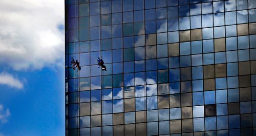 PHIL HOSSACK / WINNIPEG FREE PRESS  -  A pair of windowashers hang suspended in the clouds while working on the Great West Life building on St Mary's avenue Monday morning......STAND-UP .  -  June 5, 2017