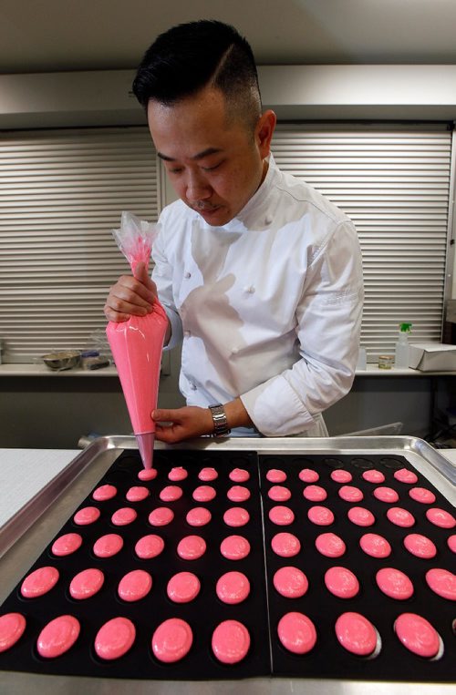 PHIL HOSSACK / WINNIPEG FREE PRESS  -  INTERSECTION - "S Squared Patisserie" Chef Sophon Chhin squeezes sweetness onto a cookie sheet Monday at the Riverview Community Centre where he uses the kitchen to churn out sweet pasteries and more.   See Dave Sanderson story.  -  June 2, 2017