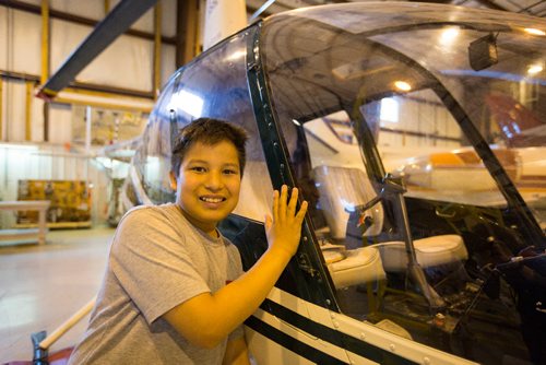 JUSTIN SAMANSKI-LANGILLE / WINNIPEG FREE PRESS
Pinkham Elementary student Fred Moar poses with one of Red River College's helicopters while on a tour of the Stevenson Campus. Students were at the facility to attend a coding lesson as part of Canada Learning Code Week.
170605 - Monday, June 05, 2017.