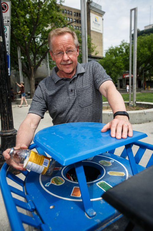 MIKE DEAL / WINNIPEG FREE PRESS
Ken Friesen, executive director of Recycle Everywhere, and a tosses out a glass bottle into one of his organizations bins at Old Market Square in the Exchange District.
170606 - Tuesday, June 06, 2017.