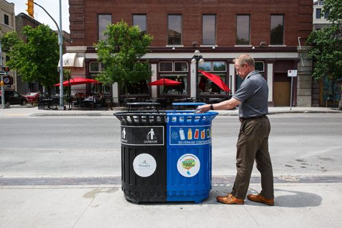 MIKE DEAL / WINNIPEG FREE PRESS
Ken Friesen, executive director of Recycle Everywhere, and a tosses out a glass bottle into one of his organizations bins at Old Market Square in the Exchange District.
170606 - Tuesday, June 06, 2017.