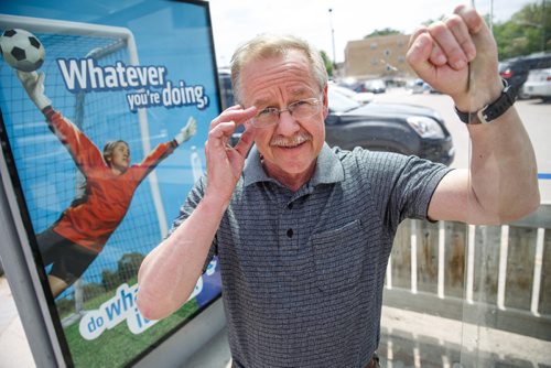 MIKE DEAL / WINNIPEG FREE PRESS
Ken Friesen, executive director of Recycle Everywhere, at a bus stop on Notre Dame Avenue with one of his organizations posters.
170606 - Tuesday, June 06, 2017.