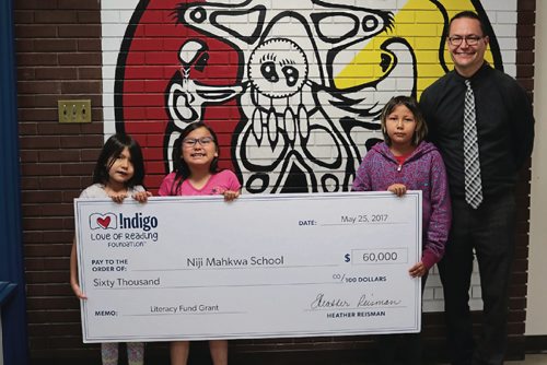 Canstar Community News May 31, 2017 - From left to right: Niji Mahkwa School Grade 2 students Jaxtynne Guiboche and Jezra Green, Grade 3 student Rihanna Laquette and principal Christopher Goring with the Indigo Love of Reading annual Literacy Fund cheque. (LIGIA BRAIDOTTI/CANSTAR COMMUNITY NEWS/TIMES)