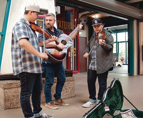 Canstar Community News (From left) Aidan, Rob, and Luc Wrigley are Double the Trouble, a fiddle based family band out of Transcona, pictured here busking at The Forks Market. (SHELDON BIRNIE/CANSTAR/THE HERALD)