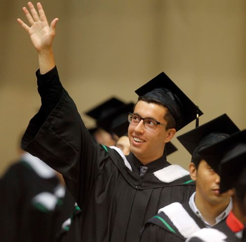 BORIS MINKEVICH / WINNIPEG FREE PRESS
University of Manitoba's 138th Annual Convocation at Investors Group Athletic Centre (IGAC), Fort Garry Campus. Computer Science grad Lorenzo Gentile waves to his dad and grandpa in the stands. June 8, 2017

