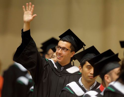 BORIS MINKEVICH / WINNIPEG FREE PRESS
University of Manitoba's 138th Annual Convocation at Investors Group Athletic Centre (IGAC), Fort Garry Campus. Computer Science grad Lorenzo Gentile waves to his dad and grandpa in the stands. June 8, 2017
