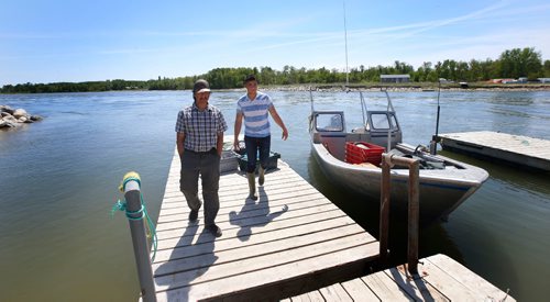 WAYNE GLOWACKI / WINNIPEG FREE PRESS

Dauphin River First Nation members and commercial fishermen Terry Stagg, with ball cap and his son Daniel Stagg with their fishing boat docked near Lake Winnipeg along the Dauphin River.   They were interviewed for Bill Redekop story. June 9  2017