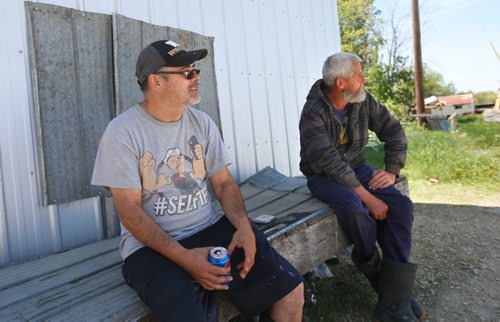WAYNE GLOWACKI / WINNIPEG FREE PRESS

At left, commercial fishermen Billy Pierce and Randy Strawa take a break in the shade of the Dauphin River Fisheries Company by the boat docks. They were interviewed for Bill Redekop. June 9  2017