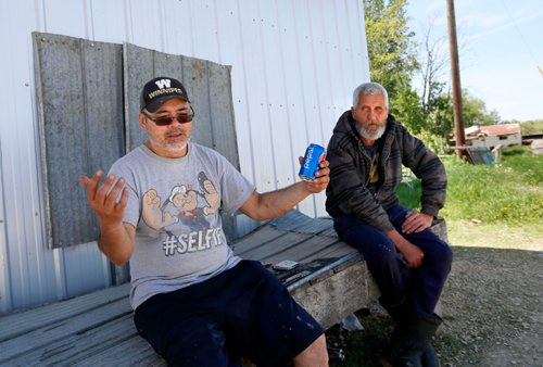 WAYNE GLOWACKI / WINNIPEG FREE PRESS

At left, commercial fishermen Billy Pierce and Randy Strawa take a break in the shade of the Dauphin River Fisheries Company by the boat docks. They were interviewed for Bill Redekop. June 9  2017